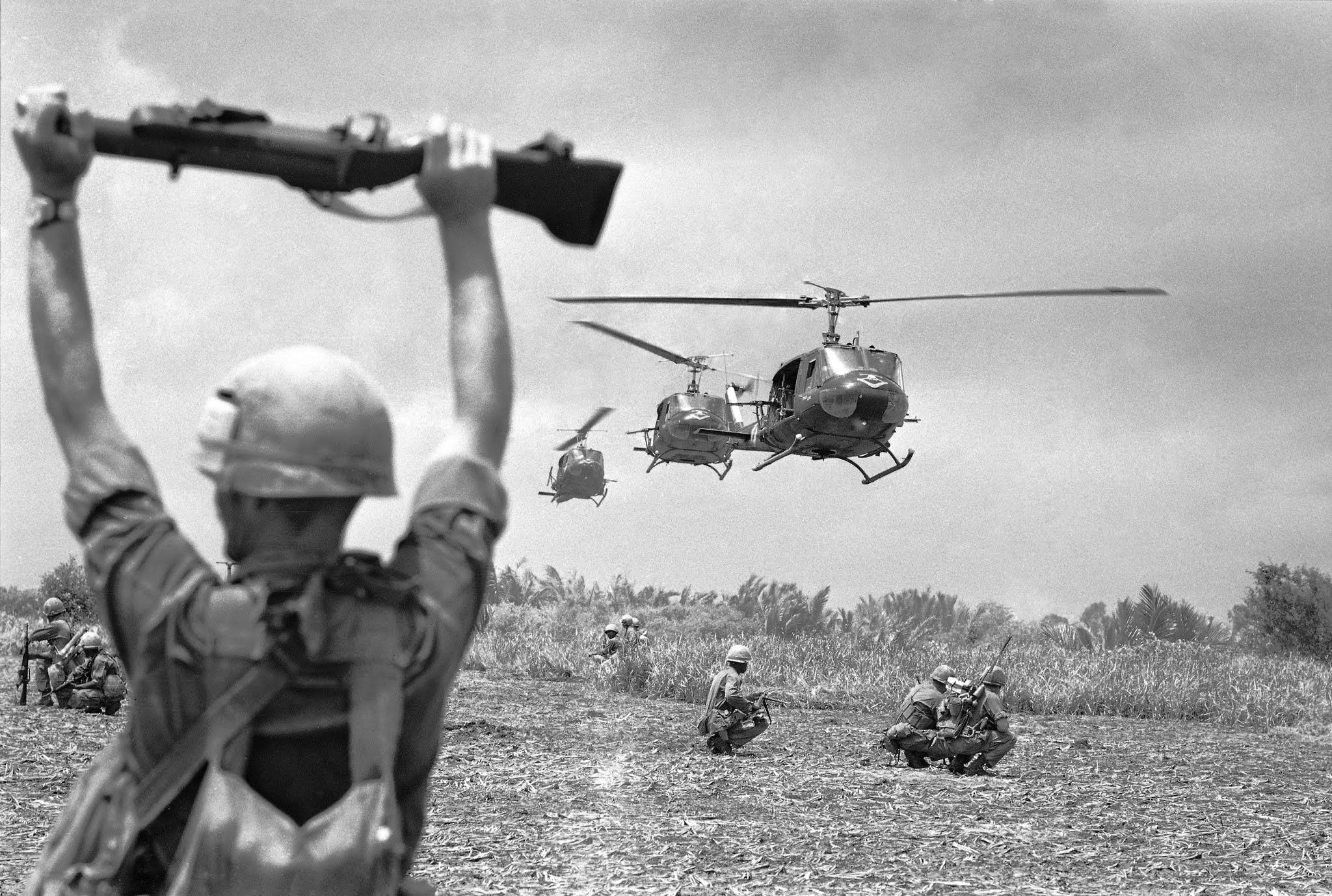 A U.S. soldier of the 9th Infantry Division uses an M79 grenade launcher to guide helicopters into an operation on the northern edge of South Vietnam's Mekong Delta in mid-July 1968. (Photo: Henri Huet / Associated Press)
